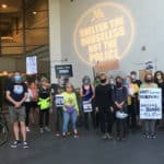 A group photo of XRPDX standing together outside the Portland Waterfront Marriott, protesting their housing of the federal agents who were battling protesters every night in July of 2020.