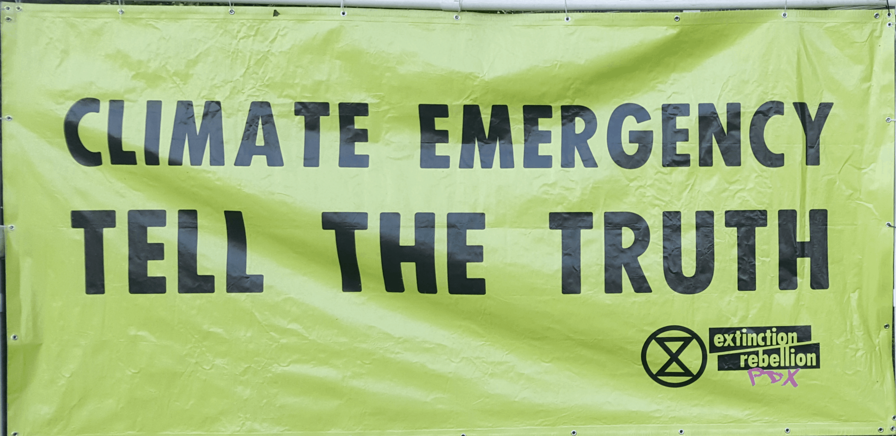 A big green banner that says "Climate Emergency: Tell the Truth