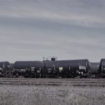 Oil train cars at the Zenith facility in Portland sit idly beneath an ominous gray sky.