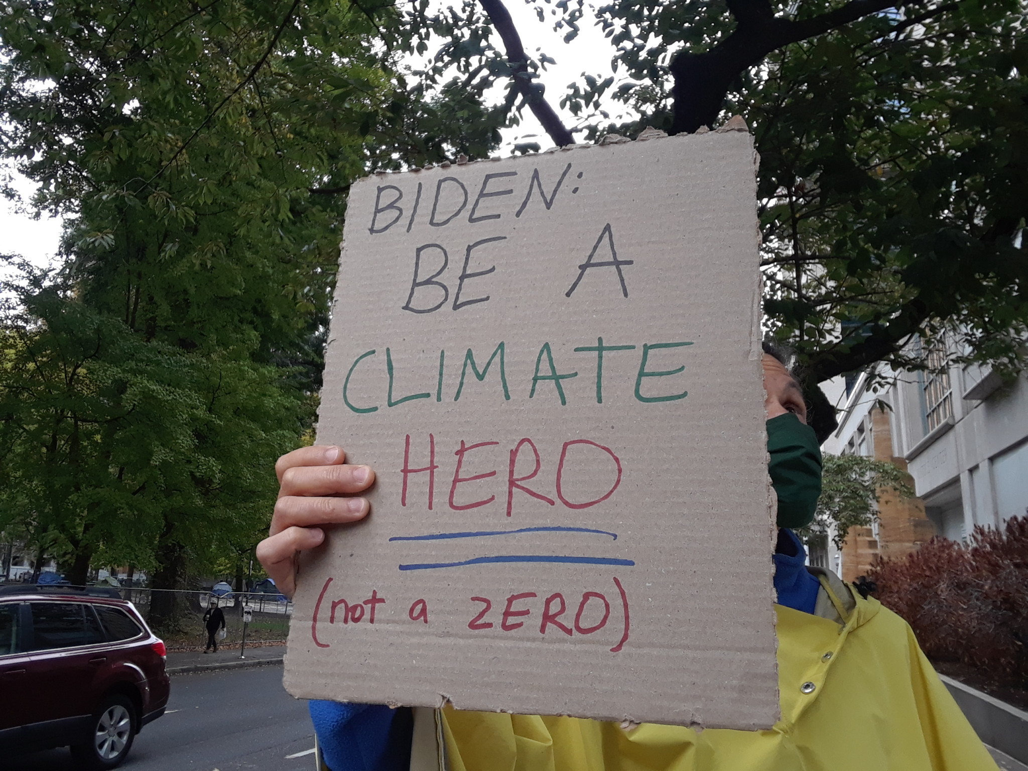 Cardboard sign reading "Biden: Be A Climate Hero (not a ZERO)