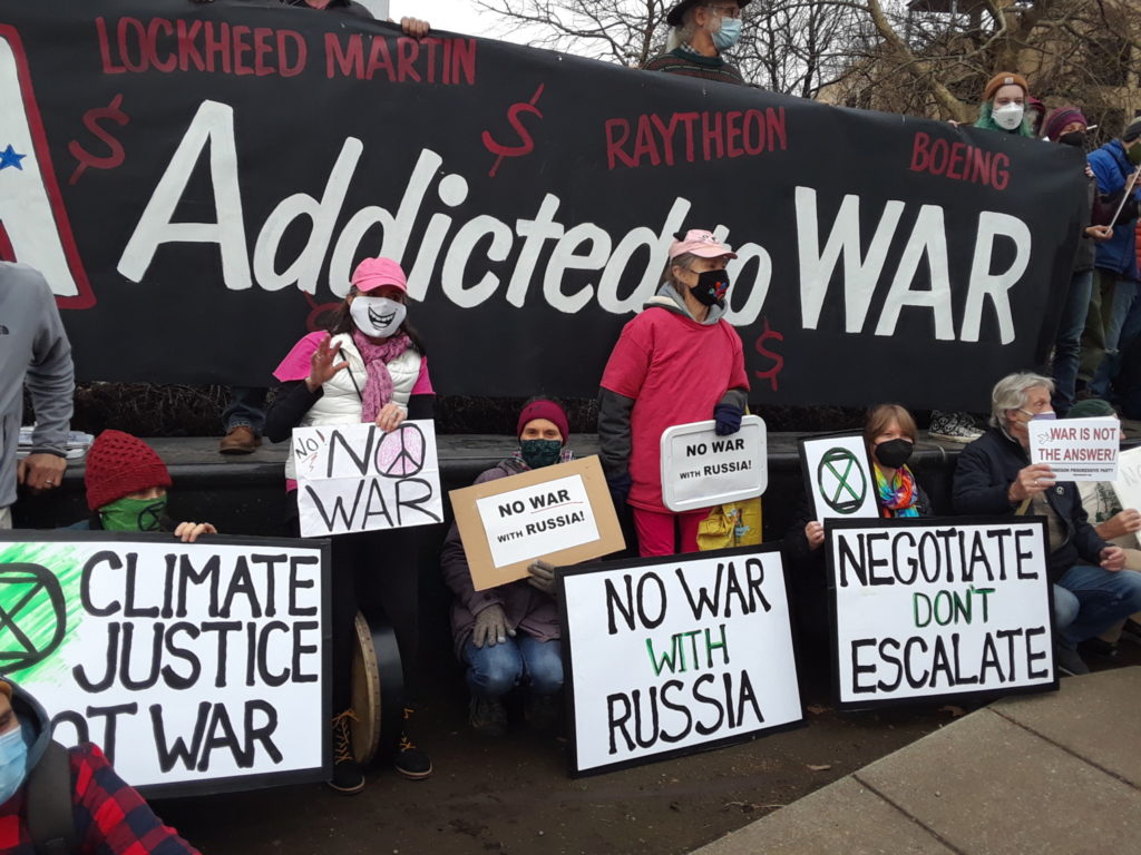 Group in front of banner reading "Addicted to WAR"