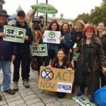 Affinity group in the UK, holding signs "Stop Ecocide"